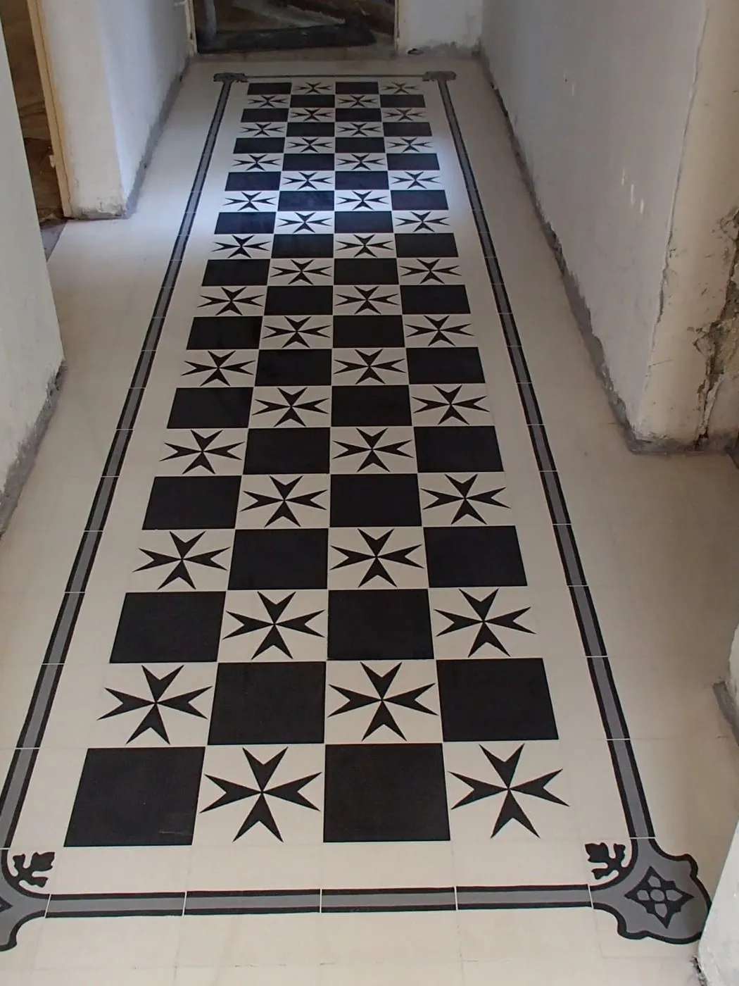A black and white checkerboard tile corridor with a star border