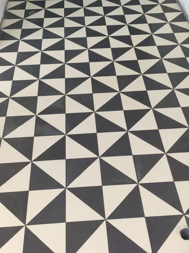 A black and white pinwheel geometric tile floor