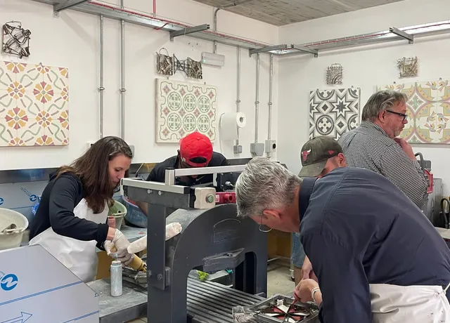 Participants working at the original tile press
